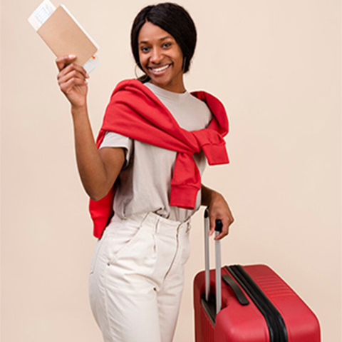 A traveller holding her travel documents, ready to depart